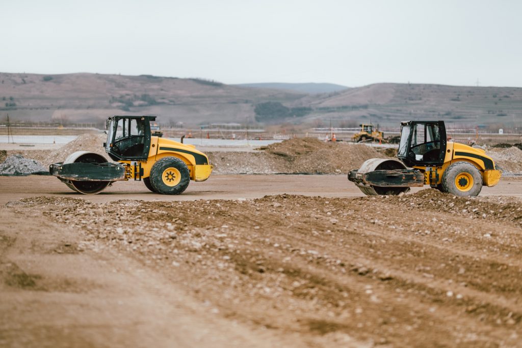 Two Vibratory Soil Compactors during road and highway construction.
